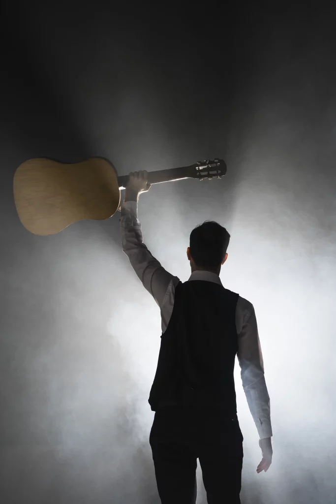 musician-stage-holding-his-classical-guitar