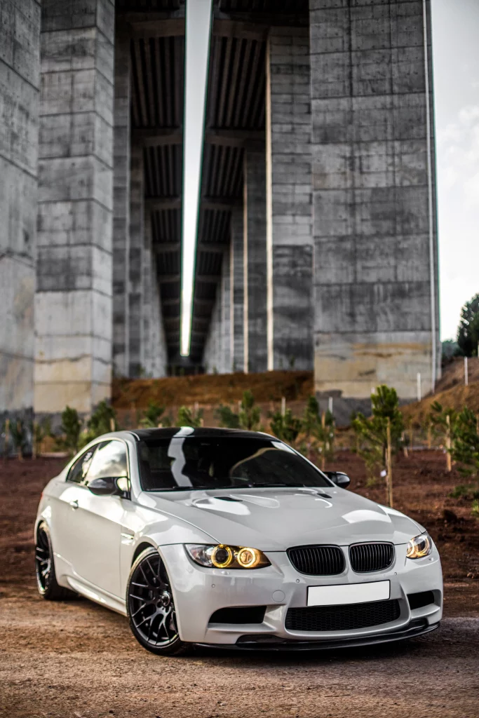 white-sport-car-standing-bridge